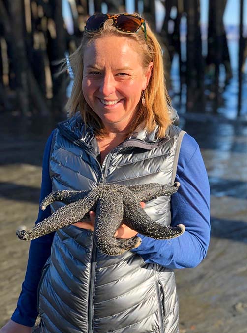 woman posing with starfish